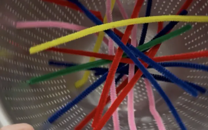 Pipe Cleaners through a Colander: A Toddler Fine Motor Activity (Ages 2-4)